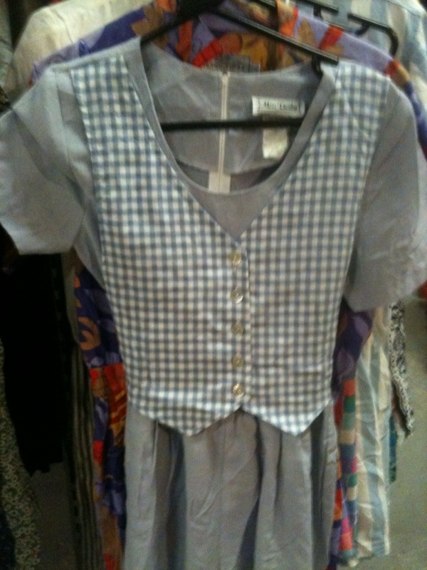 Two key trends in one with this utility inspired dress with gingham waist coat